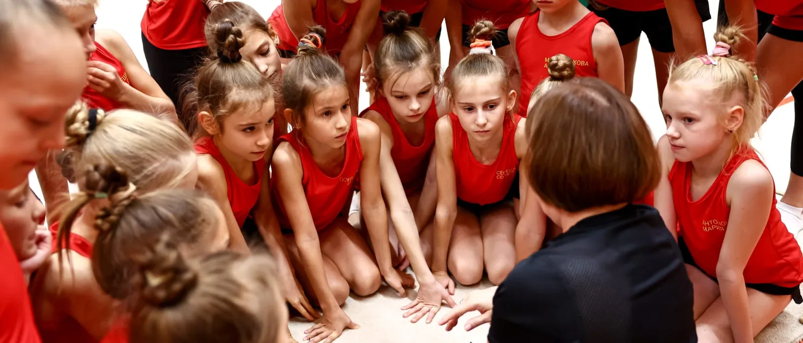 Marina Protasova working with a gymnast